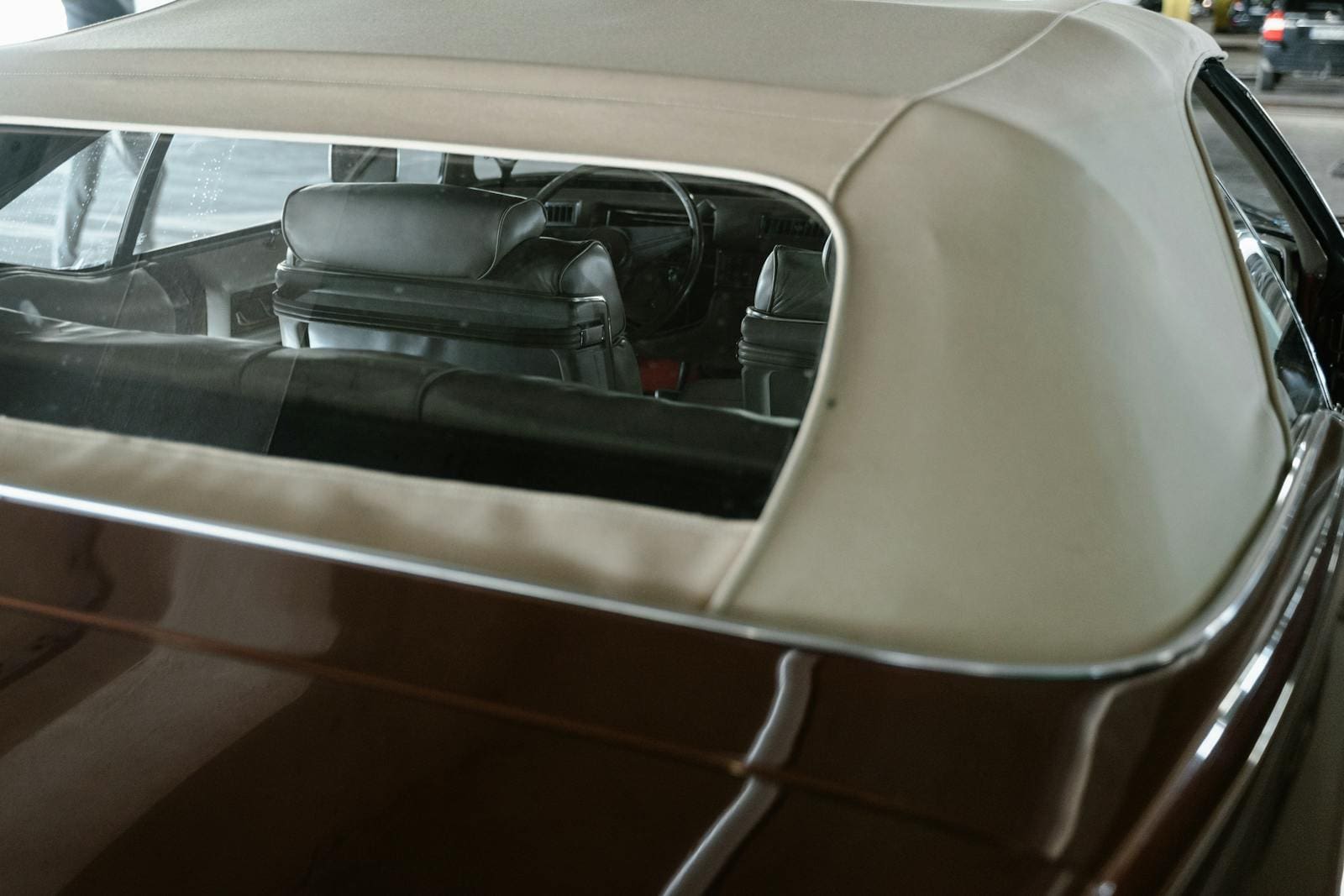 Close-up view of the interior of a vintage convertible car with elegant leather seats.